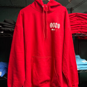 A red hooded jacket hangs on a rack with the Hoopa Valley Tribe logo showing