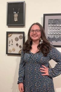 A girl is standing in front of a wall with some wall displays